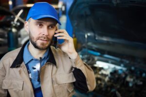 Auto Mechanic Talking On Phone